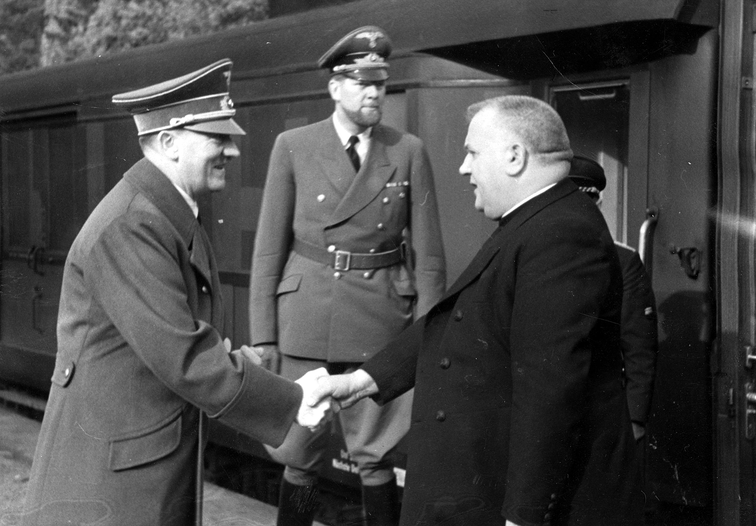 Adolf Hitler greeting the slovakian president Dr. Jozef Tiso at the station near Wolfsschanze, the head of the Protocol Department of the Foreign Office Alexander von Dörnberg is between them